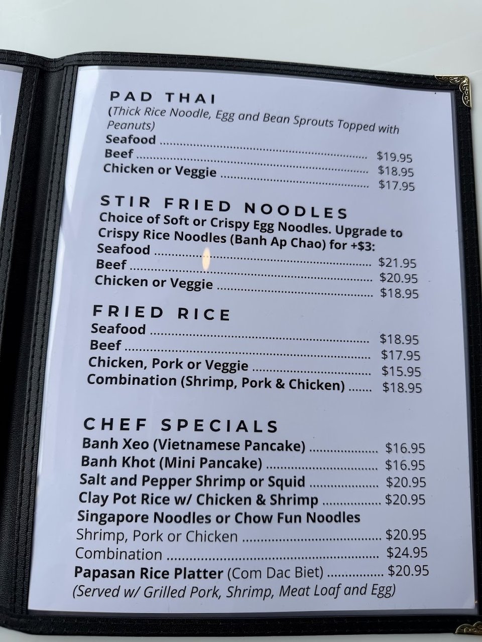 Close-up of a menu listing wings and egg rolls.